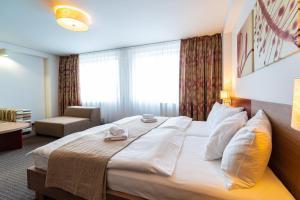 A bed or beds in a room at Hotel Ali Baba