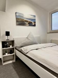 um quarto com uma cama e um quadro na parede em Ferienwohnung Flaming House Bitterfeld em Bitterfeld