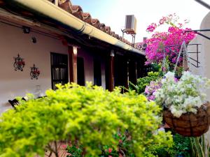 un bouquet de fleurs dans des paniers sur le côté d'un bâtiment dans l'établissement Hotel Villa de Mompox, à Mompos