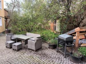 un patio con griglia, tavolo e sedie di Franks kleines Bauernhaus in Dresden a Dresda