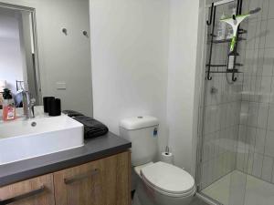 a bathroom with a toilet and a sink and a shower at Wonderful Jubilee Estate House in Wyndham Vale