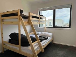 a room with two bunk beds and a window at Wonderful Jubilee Estate House in Wyndham Vale