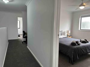 a bedroom with a bed and a window at Wonderful Jubilee Estate House in Wyndham Vale