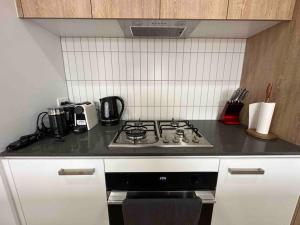 a kitchen with a stove and a counter top at Wonderful Jubilee Estate House in Wyndham Vale