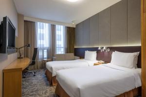 Voodi või voodid majutusasutuse LeafIN Hotel Beijing Minzuyuan toas