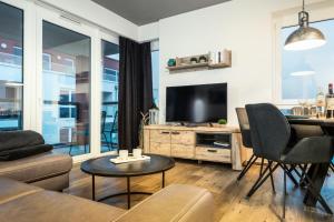 a living room with a couch and a tv at Ferienwohnung Residenz Bollwark in Kappeln