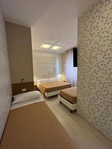 1 Schlafzimmer mit 2 Betten und einer Steinmauer in der Unterkunft Hotel Europa Parking in Livorno