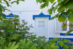 una casa blu e bianca con finestra di Cem Sentido - Alentejo Apartments a Portalegre