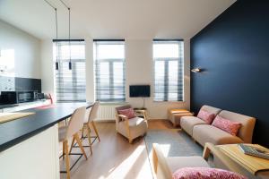 a living room with a couch and a table at à la pointe de l'ile in Namur