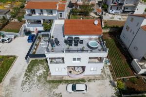 an aerial view of a white house at luxury apartment with garden jacuzzi in Trogir