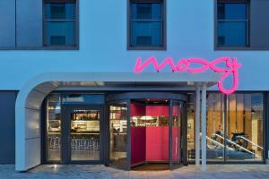 a store front with a neon sign on it at Moxy Munich Ostbahnhof in Munich