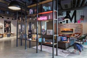 a room with a shelf with many items on it at Moxy Munich Ostbahnhof in Munich