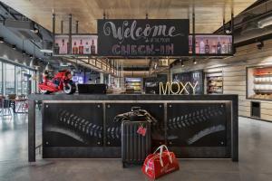 a store with a motorcycle parked behind a counter at Moxy Munich Ostbahnhof in Munich