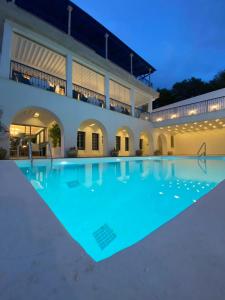 a large swimming pool in front of a building at La Menara Hotel & SPA in Sidi Bou Saïd