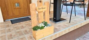 un cartel de madera con flores en una caja de madera en Hős-Ceglédi Vendégház Miskolc -Önálló otthon, mely csak az Önöké, en Miskolc