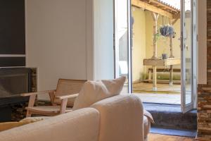 a living room with a couch and a fireplace at Charming Apt in Historic House in Coimbra