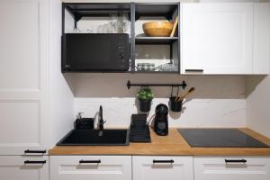 a kitchen with a sink and a microwave at Charming Apt in Historic House in Coimbra