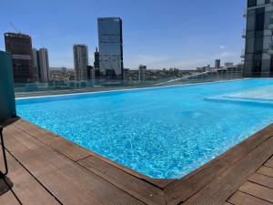 a large swimming pool on the roof of a building at Apartamento en Lobby33 in Guadalajara