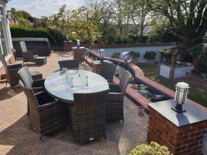 a patio with a table and chairs and a water slide at Best Area Close to Leeds Centre in Leeds