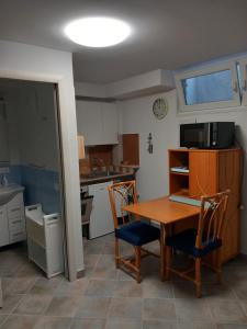 a kitchen with a table and two chairs and a kitchen with a sink at Residence Sole Dell'Argentario in Porto Santo Stefano