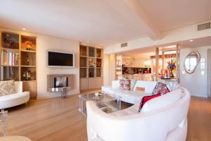 圣特罗佩RARE! Appartement, 100m2, Climatisé - Port de Saint-Tropez的客厅配有白色家具和电视