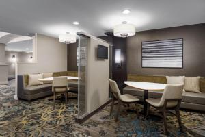 a lobby with a table and chairs and a couch at Residence Inn Hartford Rocky Hill in Rocky Hill