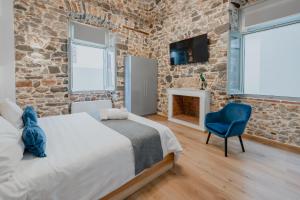 A bed or beds in a room at Impero Nafplio Hotel & Suites