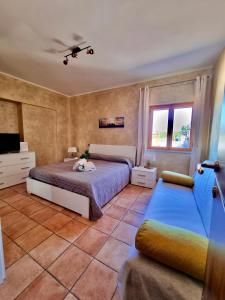 a bedroom with two beds and a tv and a couch at Acquamarina in Gaeta