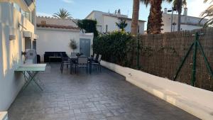 a patio with a fence and a table and chairs at Rodhes Playa B-1 in Roses