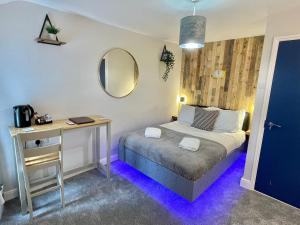 um quarto com uma cama, uma secretária e um espelho em Cloud9 Guest House - by Coastline Retreats - Newly Renovated, Beautiful Ensuite Rooms Near Seafront in Town Centre, Netflix, SuperFast WiFi, Communal Kitchen em Bournemouth