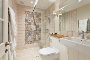 a bathroom with a toilet and a sink at The Inn West End in Woking