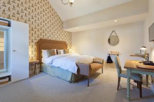 a bedroom with a bed and a desk and a desk at The Inn West End in Woking