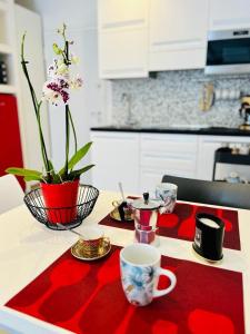 a table with a red table cloth on a kitchen counter at Grazioso bilocale in centro storico in Verbania