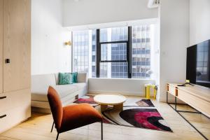 a living room with a couch and a table at Placemakr Wall Street in New York