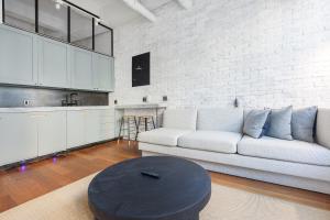 a living room with a couch and a table at Placemakr Wall Street in New York