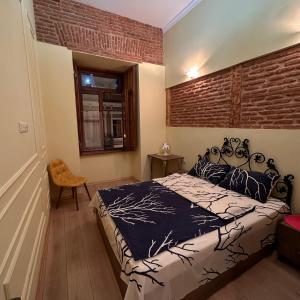 A bed or beds in a room at Historic Apartments "1868 Tbilisi" Best Location