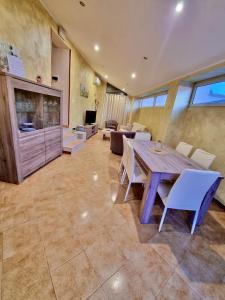 a large room with a wooden table and chairs at Acquamarina in Gaeta