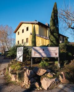 um sinal em frente a uma casa com um edifício em Hotel Ristorante Vecchia Riva em Varese