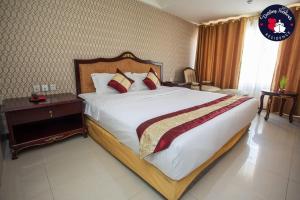 A bed or beds in a room at Darling Harbour Residence - South Pattaya