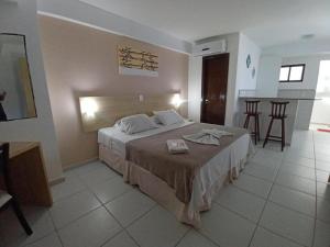 a bedroom with a large bed in a room at Marsallis Praia JR 408 in Natal