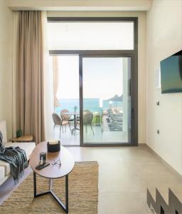 a living room with a view of the ocean at Akrotiri Olympus Luxury Suites - Adults Only in Plaka Litochorou