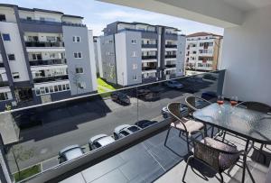 a balcony with a table and chairs and buildings at Exclusive Apartment SIBIU in Sibiu