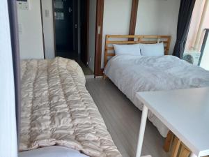 Cama ou camas em um quarto em オリエントシティ南堀江Ⅱ