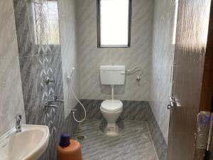 a bathroom with a toilet and a sink at Hotel Sai viraj palace in Shirdi