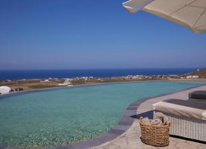 a swimming pool with a view of the ocean at Danae Suites Santorini in Oia