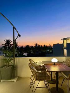 a patio with a table and chairs on a balcony at Serene La Playa Boracay in Boracay