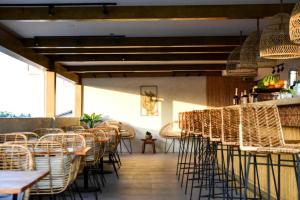 a restaurant with chairs and tables and a bar at Serene La Playa Boracay in Boracay