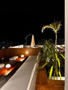 a balcony with tables and plates and a palm tree at Serene La Playa Boracay in Boracay