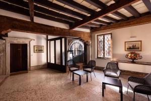 a room with chairs and a table and a window at Residence Ca' Foscolo in Venice