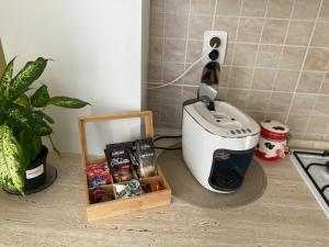 a kitchen counter with a toaster and a box of food at Apartament Terra II in Floreşti